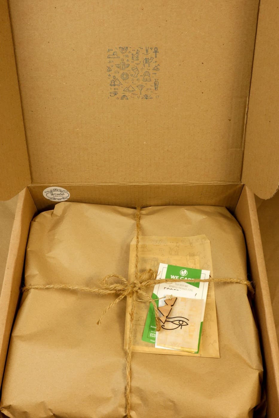 Rigid box opened to reveal a wrapped product and fitted interior