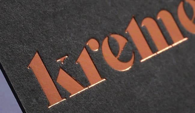 Copper foil stamping on a dark textured board, produced at JSS The Print Zone